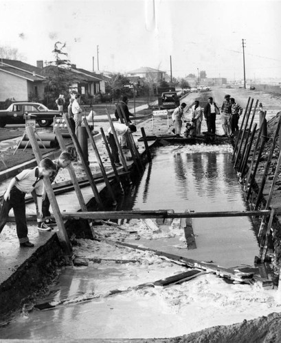 Broken pipe creates swimming pool