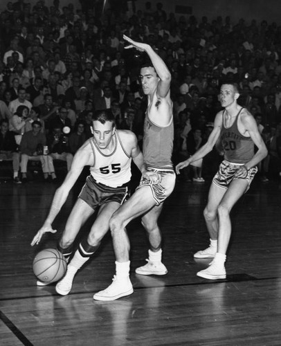 Jim Jones of Granada Hills dribbles around Uni Hi player