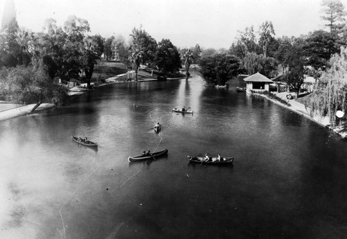 Canoers enjoy the lake at Hollenbeck Park