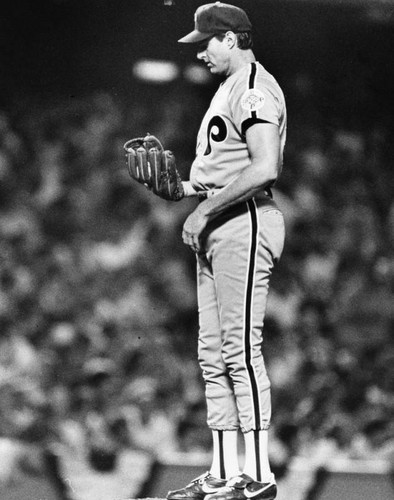 Pitcher looks at his glove