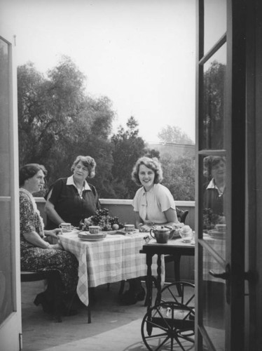 Ethel Schultheis having tea with friends at home