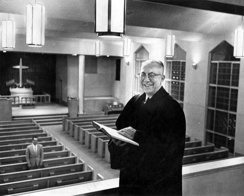 Rev. Elmer Ude inspects new sanctuary interior