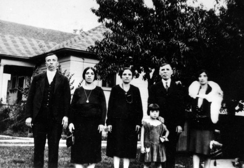 Family members in front of their house