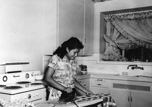 American Indian woman ironing