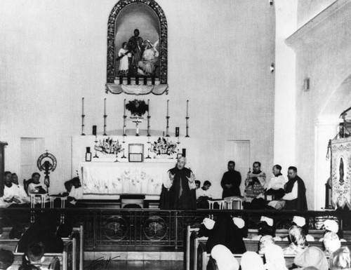 Interior of Holy Family Catholic Church during mass — Calisphere