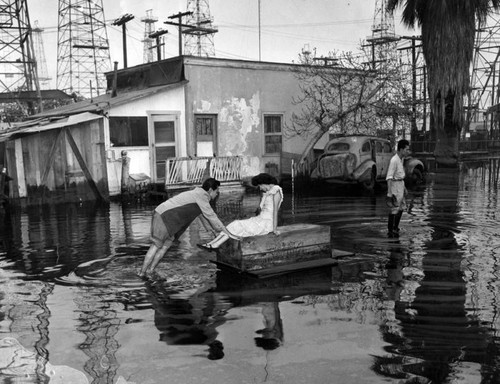 Long Beach wife 'rescued' by raft from high tide waters