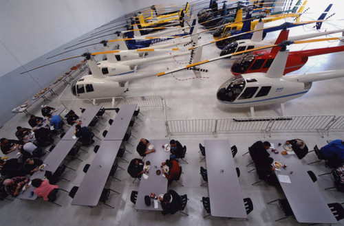 Student pilots eat lunch in delivery hangar