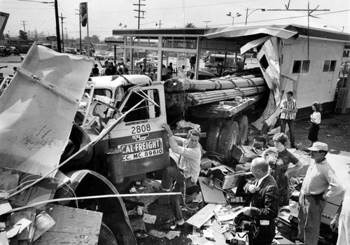 Big truck batters gas station, cars