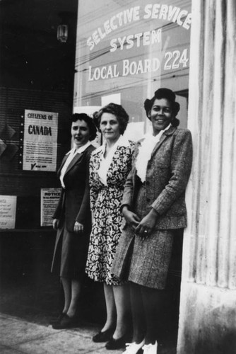 Women pose for photo outside of Selective Service office