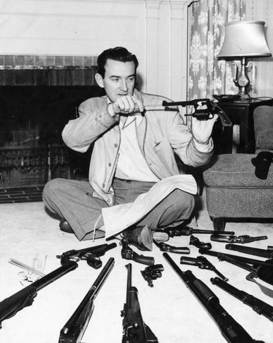 Judd McMichael cleaning gun collection
