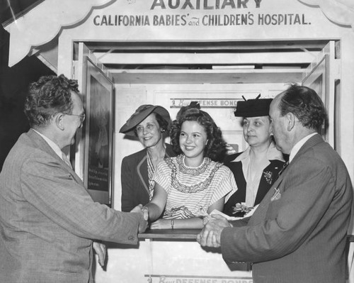 Actress Shirley Temple at auxiliary booth for War Bonds and Stamps