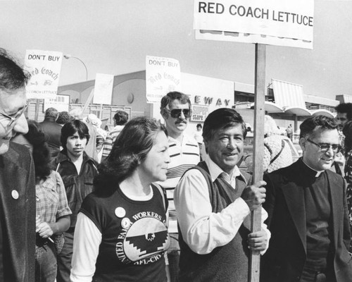 Chavez walks with picket sign