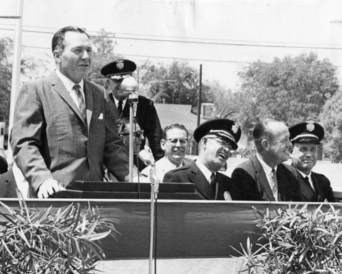 Mayor Sam Yorty, standing, speaks at Foothill station opening