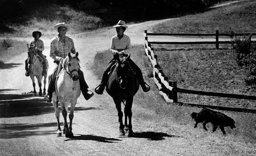 Ronald and Nancy Reagan ride down a trail