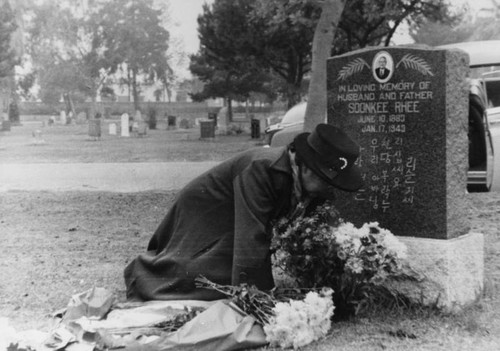 Woman tending husband's grave