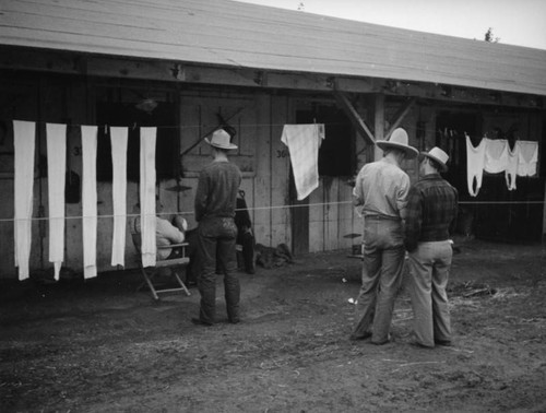 Men in front of stables at the Los Angeles County Fair