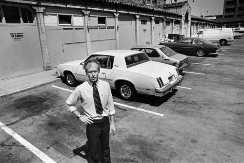 John Quinn stands in parking lot