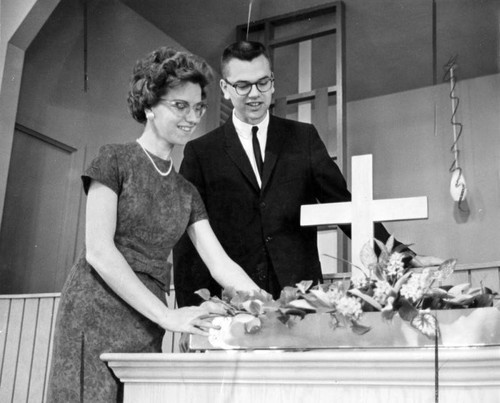 Rev. and Mrs. Gary Mann prepare altar for church service