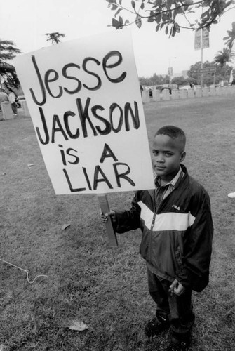 Young boy carring a protest sign