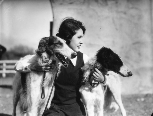 Young woman and her dogs, view 1