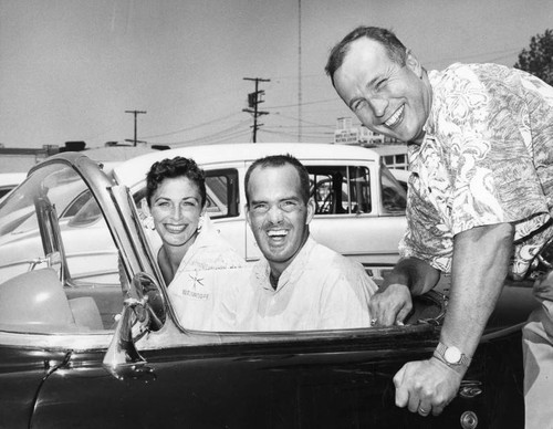 Two guys, a gal and a car