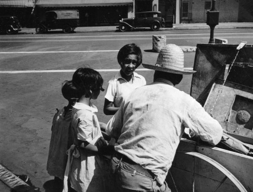 Children speaking to a man near the Plaza