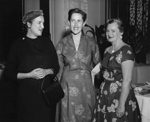 Three women attend a fashion show