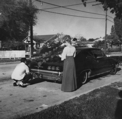 Mexican Americans decorating a car for a wedding