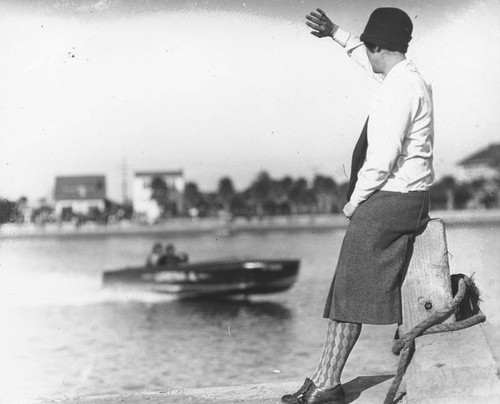 Woman waves at speedboat