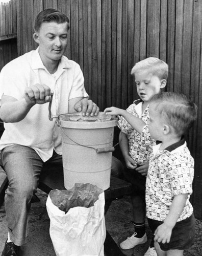 Keith Michaud turns crank as ice cream freezes