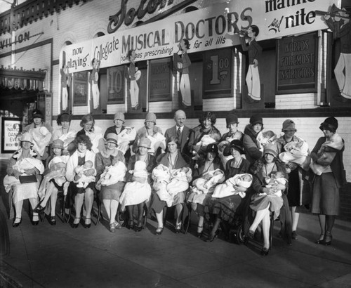 Mothers and babies outside dance hall