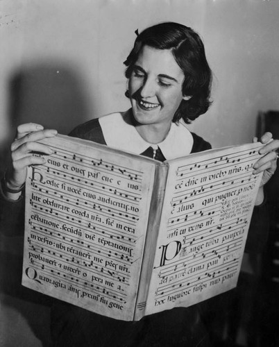 Miriam Webb holding a rare book