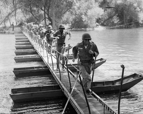 Infantry-trained engineers sprint across newly built bridge