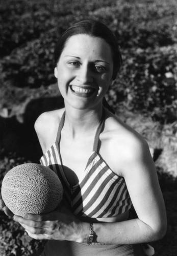 Woman with cantaloupe