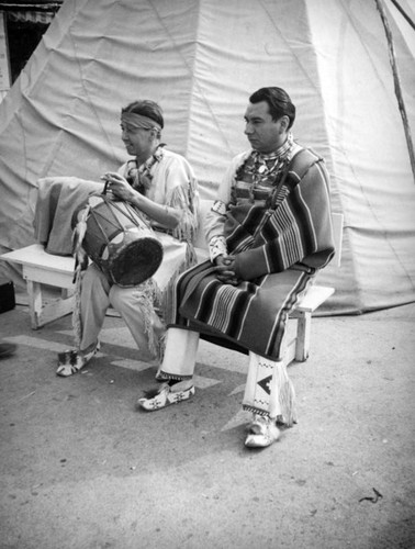 Men by a tepee at the Farmers Market Fall Festival