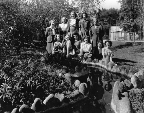 Instructors and students by a pond