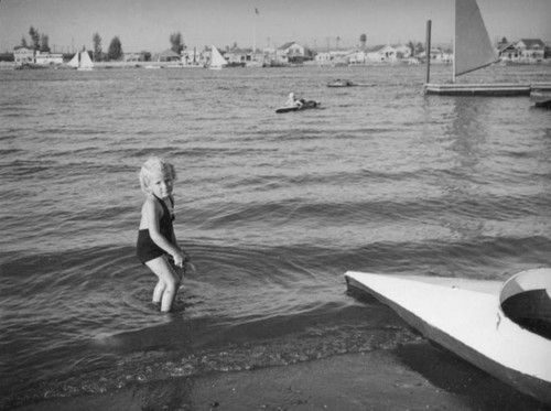 Little girl, shortboards and kayak at Balboa Beach