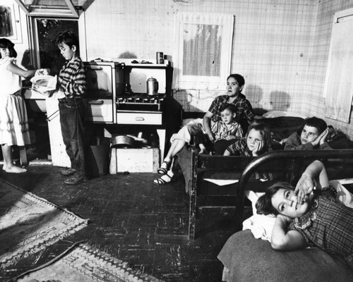 Smith family posed in their one room apartment