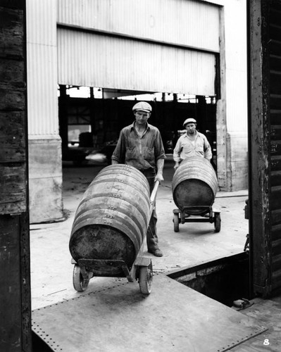 Men moving Los Angeles Brewing Co. barrels