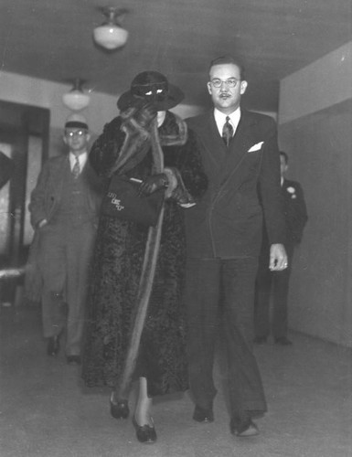 Mrs. Alice Todd, mother of Thelma, is escorted by Harvey Priester, an insurance councilor for movie stars who was reportedly the last fiancé of Thelma. They were called to the grand jury for questioning.