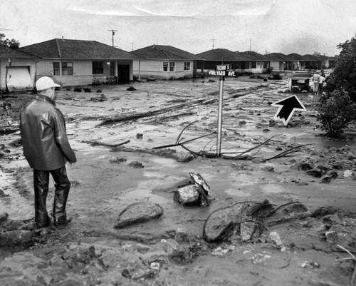 Truck and homes half-buried in silt