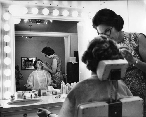 Jean Rasche, Max Factor Artist, cleanses Lucille Ganz's face