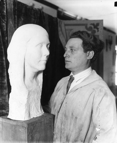 Sculptor with his work