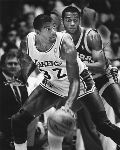 Terry Teagle of the Golden State Warriors guards Magic Johnson