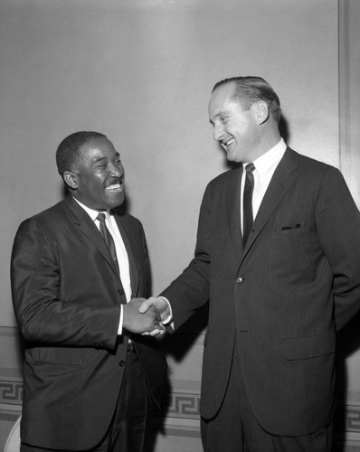 Congressional District Representative Thomas Rees shakes hand with unidentified man