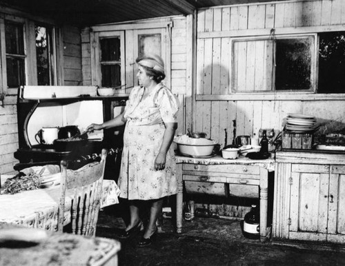 Rita Duarte in her kitchen, slum homes