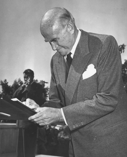 Samuel Goldwyn signs guest book at service