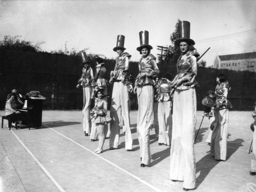 Auto Club girl chorus on stilts