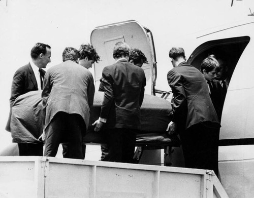 Taking Kennedy aboard plane