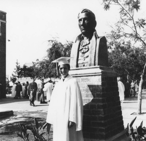 Marshall graduate by statue